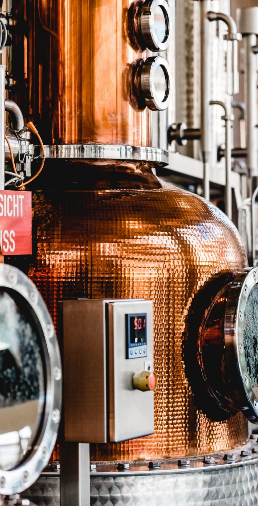 alembic still for making alcohol inside distillery, destilling spirits